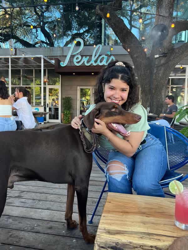 Diana at restaurant with dog